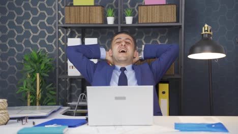 Businessman-finishing-his-work-and-relaxing.