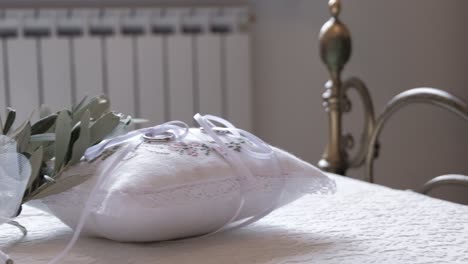 wedding-rings-on-a-bed