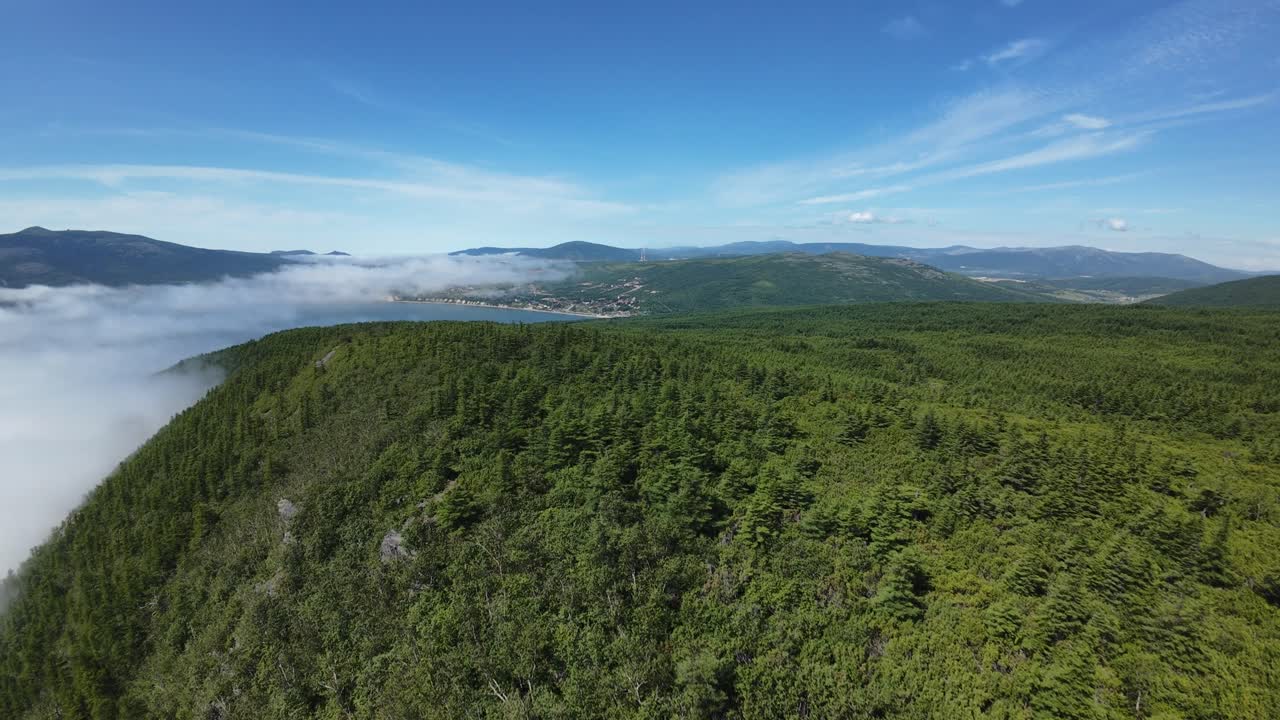 Enjoy nature’s peace as the camera sweeps over lush hills and distant mountains
