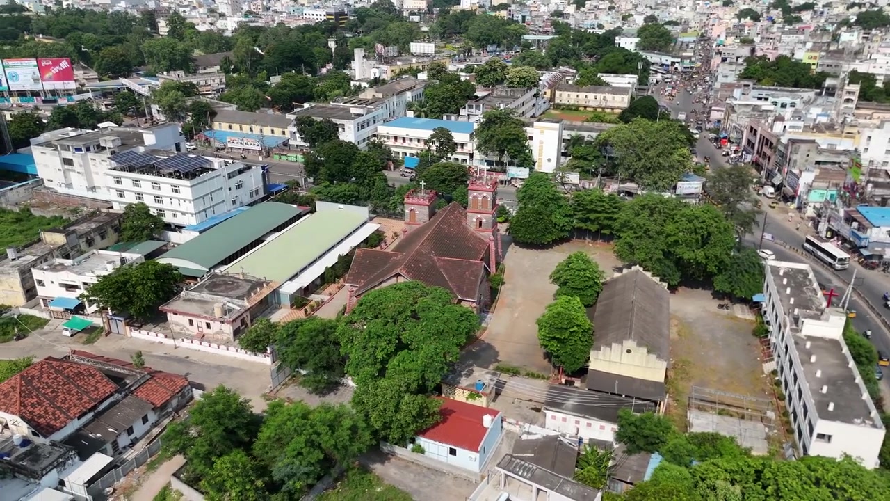Riprese drone di Vijayawada che catturano il vivace paesaggio urbano e la vegetazione circostante con una collina prominente in lontananza