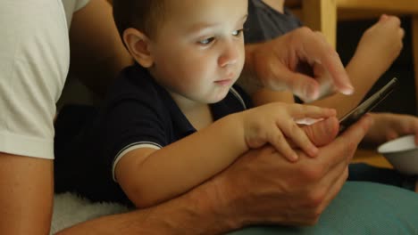 Side-view-of-caucasian-father-and-children-using-digital-tablet-in-a-comfortable-home-4k