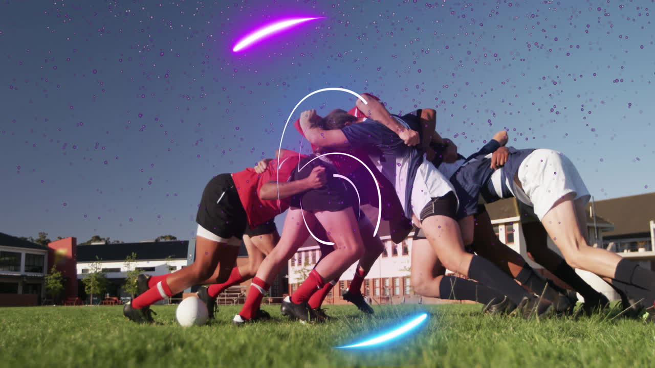 Male rugby players pushing over ball on sports field, showing neon purple and blue light overlays