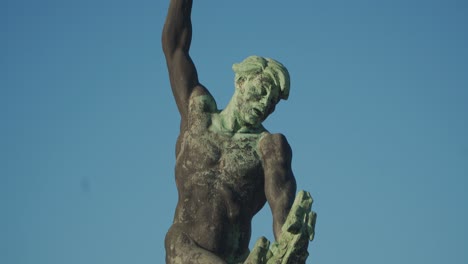 statue of a hungarian warrior fighting a three-headed dragon on top of gellert hill, budapest, hungary - tilt up shot
