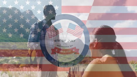 Animation-of-independence-day-text-over-smiling-diverse-couple-looking-away-and-hiking