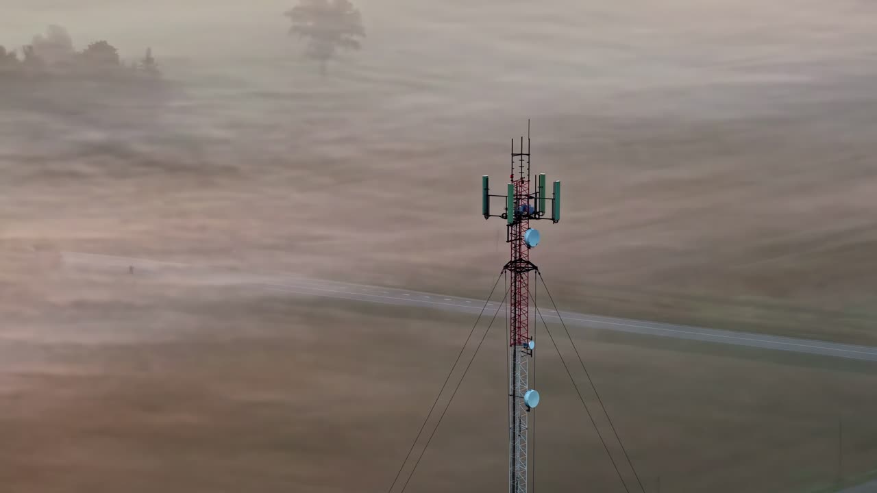 Aerial View Of Cell Phone Tower With Foggy Landscape In The Background. - closeup shot