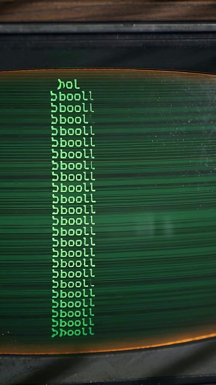 Vertical video: Refreshing curved CRT at bench showing centered bool column, prompt blinking