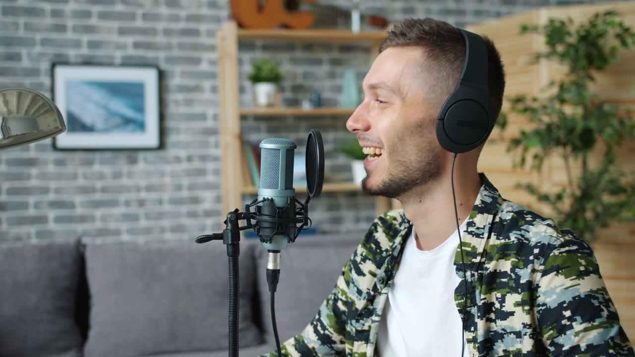 Man Singing into a Microphone in Home Studio