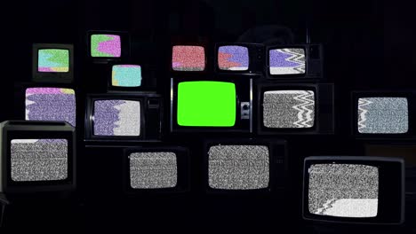 retro tvs with test pattern and noise and five old tvs turning on green screen.