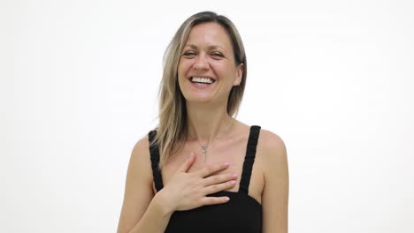 smiling woman with hand on chest on a white background