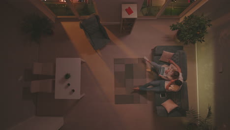 young couple sitting on couch
