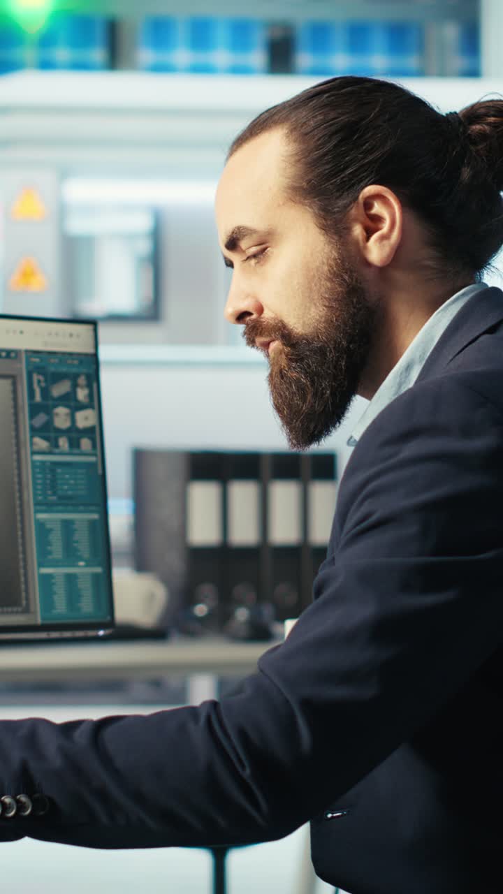 Vertical Video Photovoltaics Factory Worker Monitors System Performance, Drinking Coffee