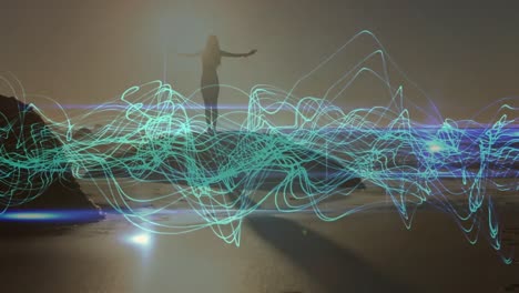 animation of blue lines over caucasian woman praciticing yoga on beach