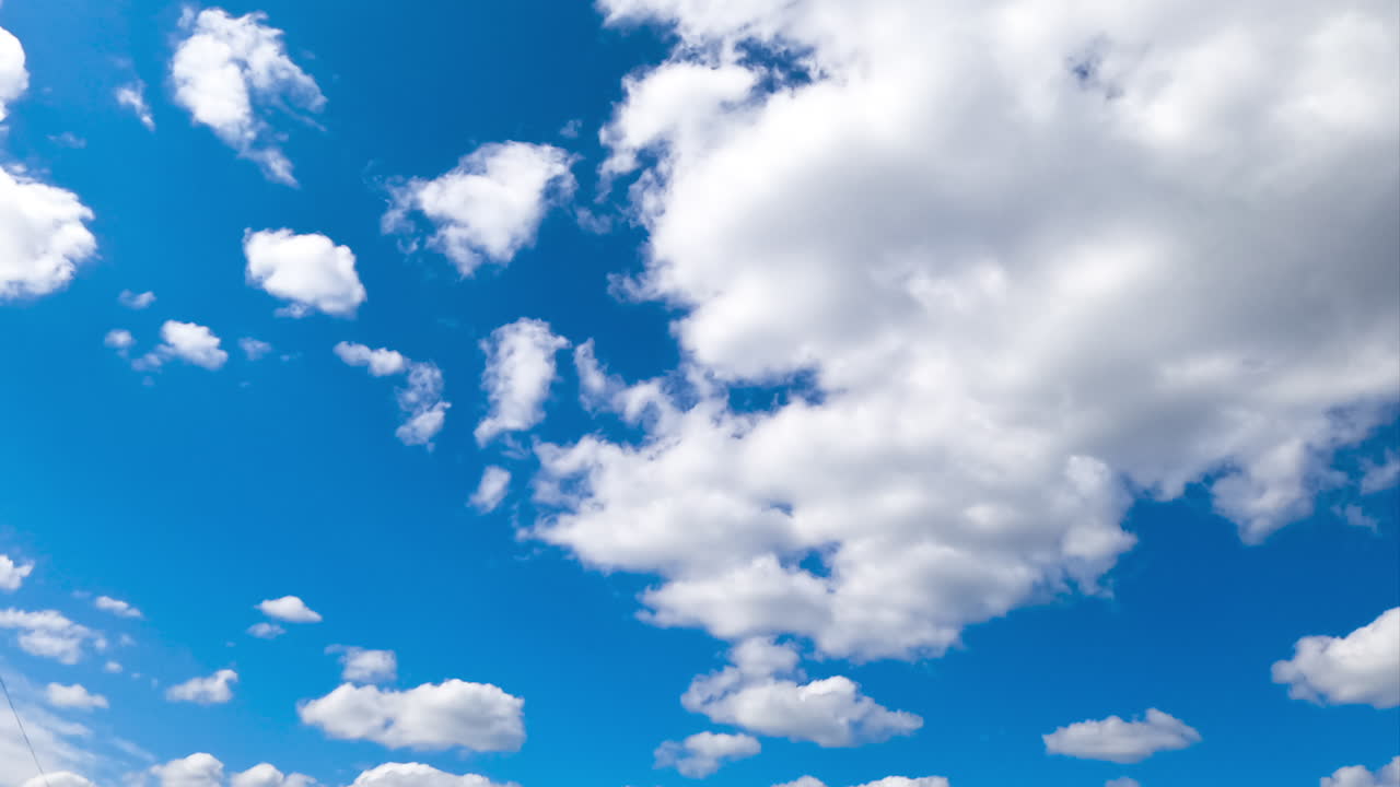Bright amazing azure skies with beautiful cumulus clouds quickly changing shapes. Quick cloud transformation timelapse.