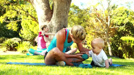 woman exercising with her baby