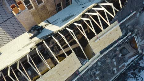 aerial drone bird's eye view of burnt roof structure of a house pn a sunny day