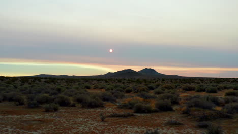 low-altitude flight towards the rising sun with hazy smoke left behind by wildfires