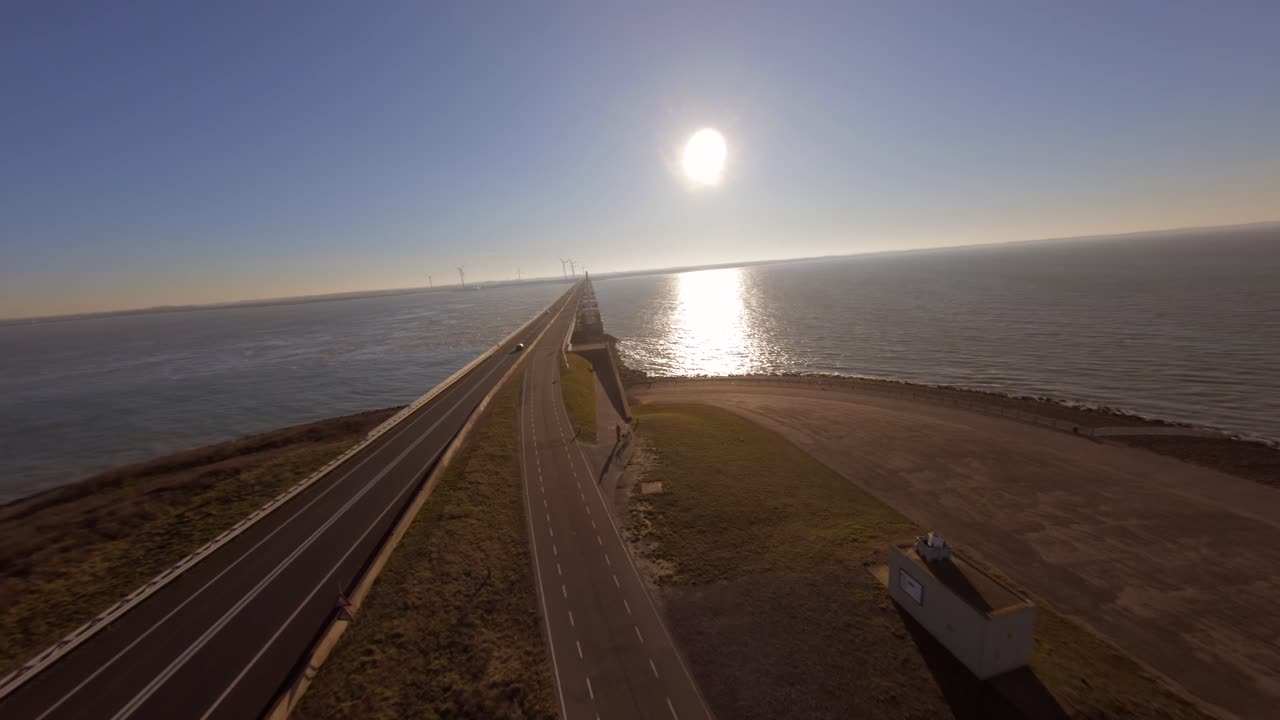 Low to high angle of a car driving from a island onto the storm surge barrier bridge
