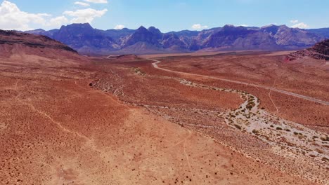 Enfoque-Aéreo-Del-Cañón-De-Roca-Roja-Bajo-Un-Gran-Cielo-Azul