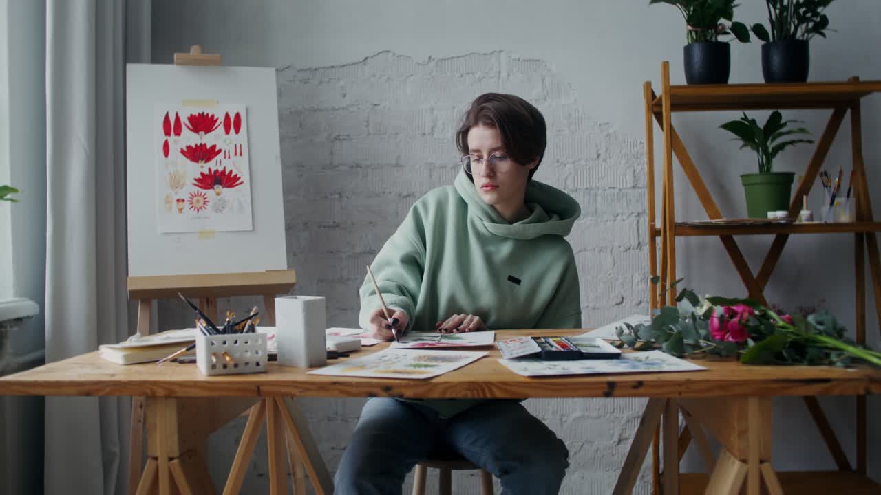 Artist Drawing Flowers in a Studio