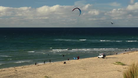 surfers enjoying strong wind on tropical hayle beach in cornwall, england