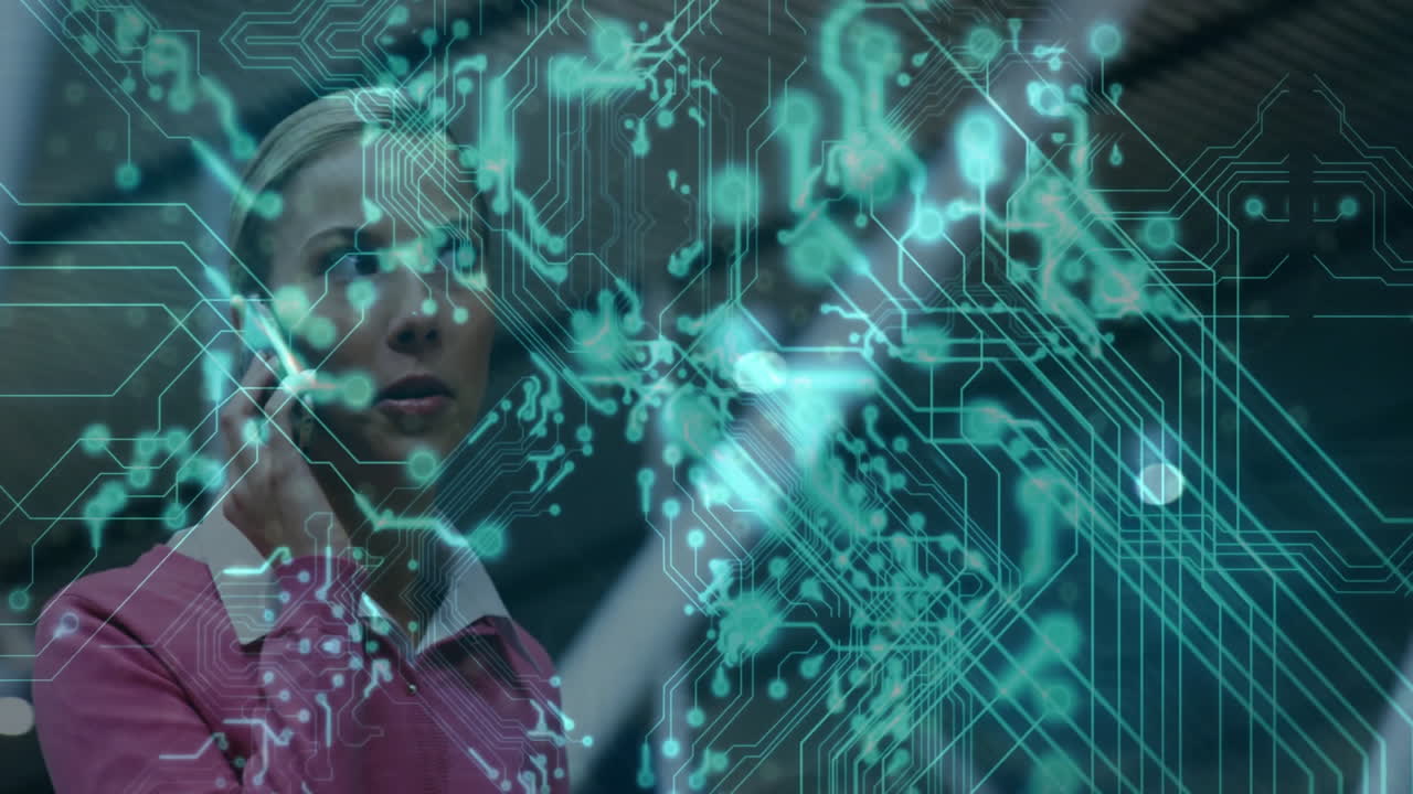 Tech professional using smartphone in modern office, projecting holographic circuitry interface