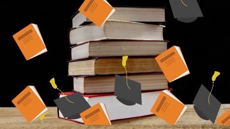 graduation hats and books falling against stack of books on wooden table against black background