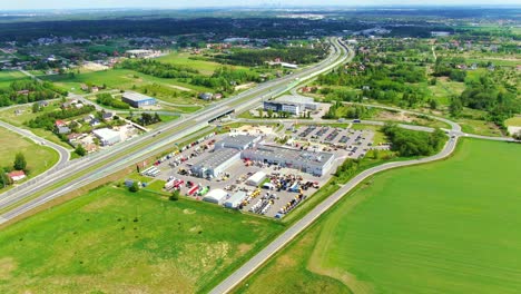 Aerial-top-down-view-of-the-big-logistics-park-with-warehouses,-loading-hub-and-a-lot-of-semi-trucks-with-cargo-trailers-awaiting-for-loading-unloading-goods-on-ramps