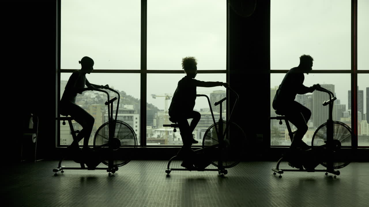 People exercising on stationary bikes in a gym