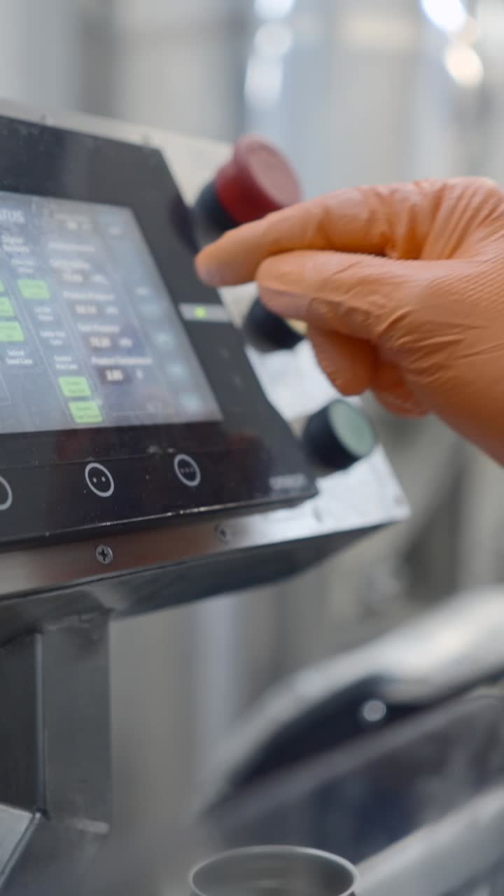 Gloved Hand Operating an Industrial Control Panel