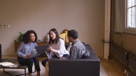 Three-young-creatives-having-a-casual-work-meeting