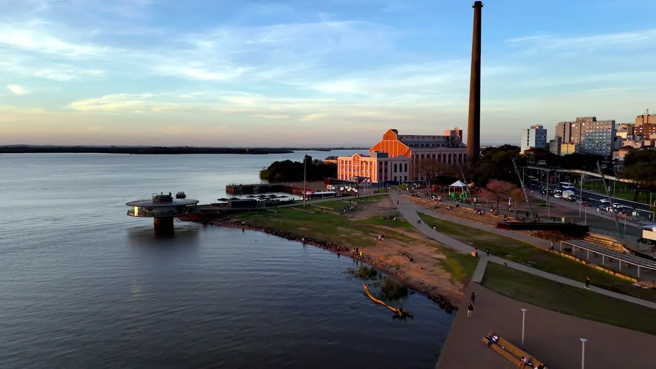 Gasometer power plant, city transportation commuters, riverside highway