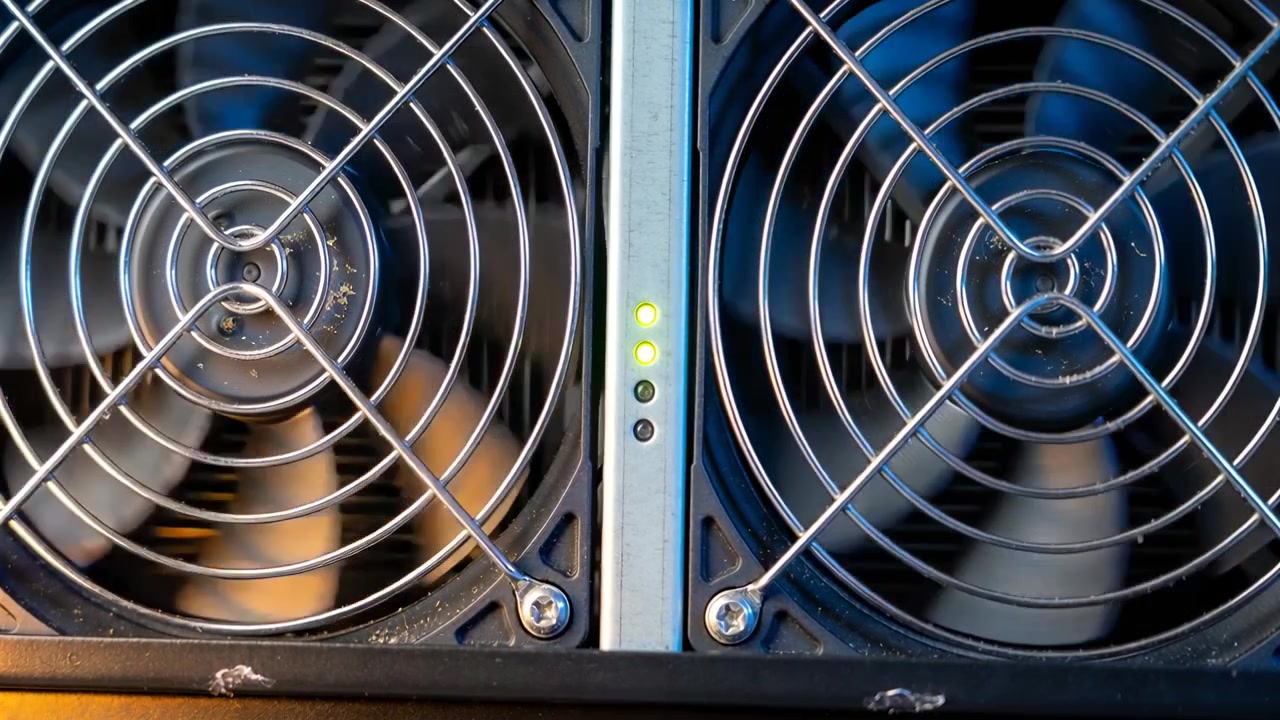 Spinning dual-fan cooling assembly rotating blades after power applied on bench, with LED strip