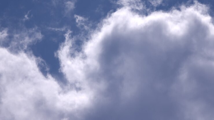 Glowing white clouds in blue sky