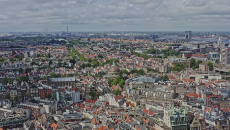 amsterdam netherlands aerial v5 drone pan shot across downtown capturing populous cityscape with traditional and modern townhouse buildings and iconic historic architectures - august 2021