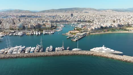 aerial tracking shot along luxury yachts on marina zeas pier, piraeus