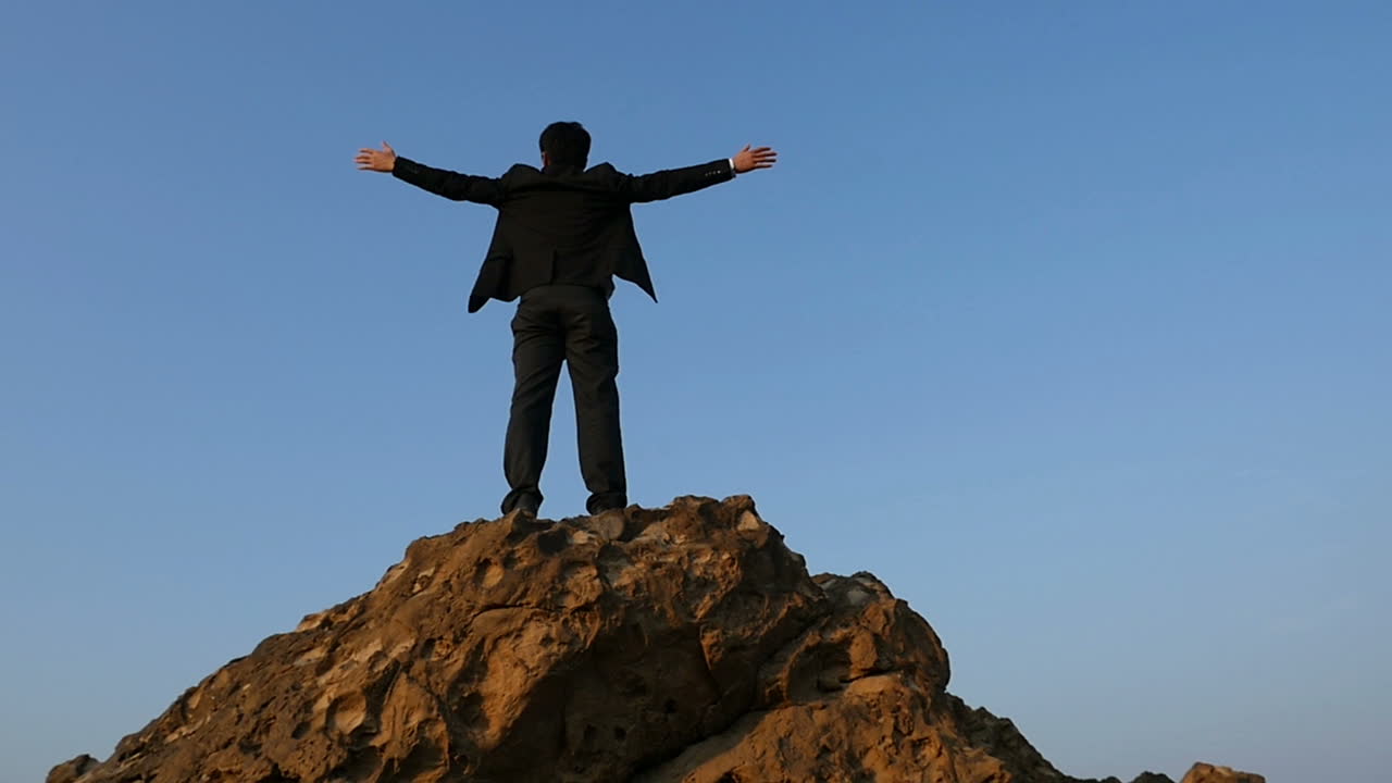 Businessman on a mountaintop