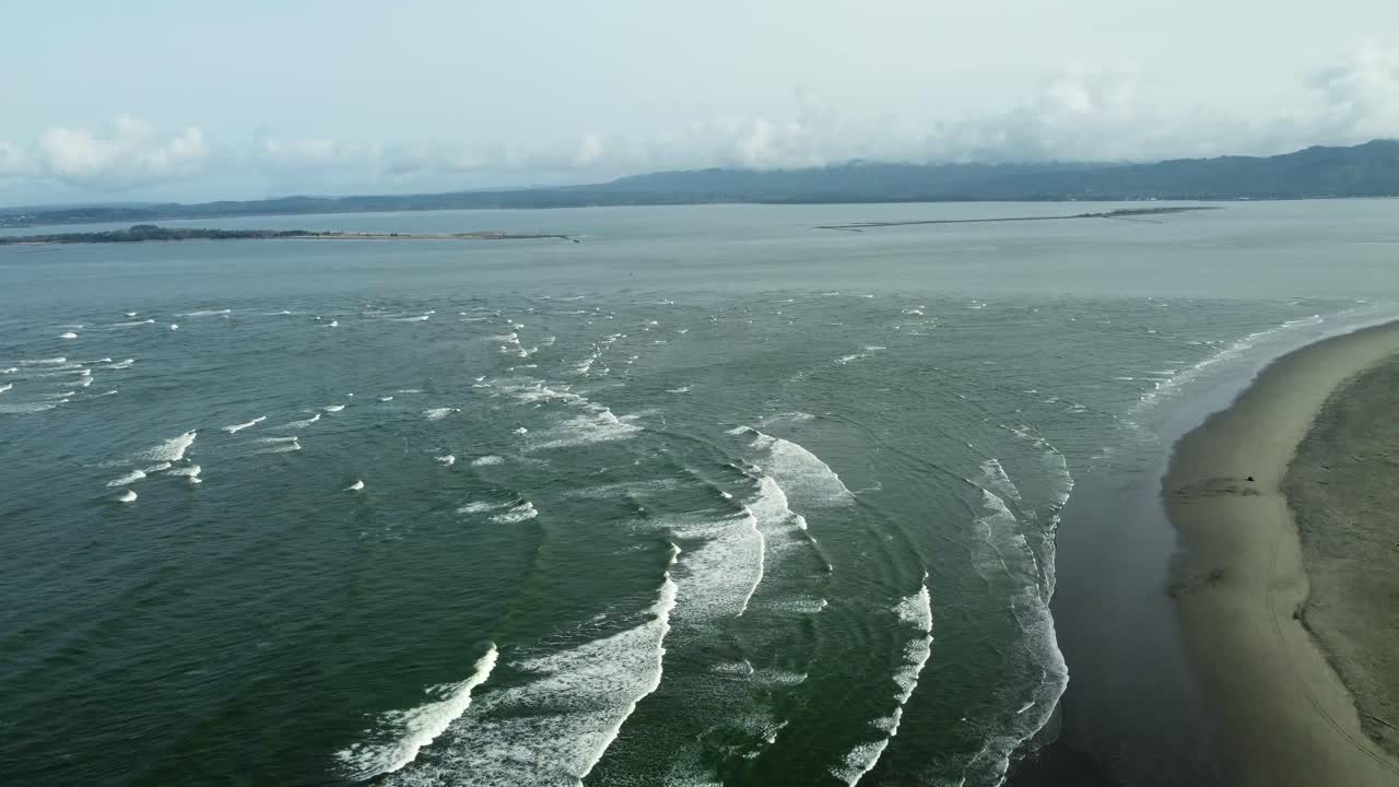 US, Oregon, Astoria, Fort Stevens, 2025-03-21 - Drone view, tip of Oregon where the Columbia River meets the Pacific Ocean. The waves come up the river so they're working against the river current.