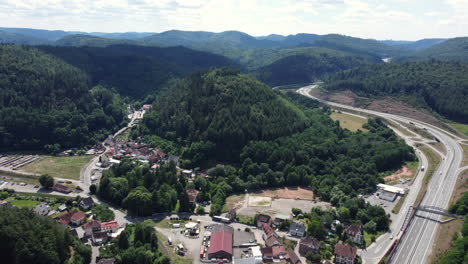 aerial view of a village and highway in a mountainous area