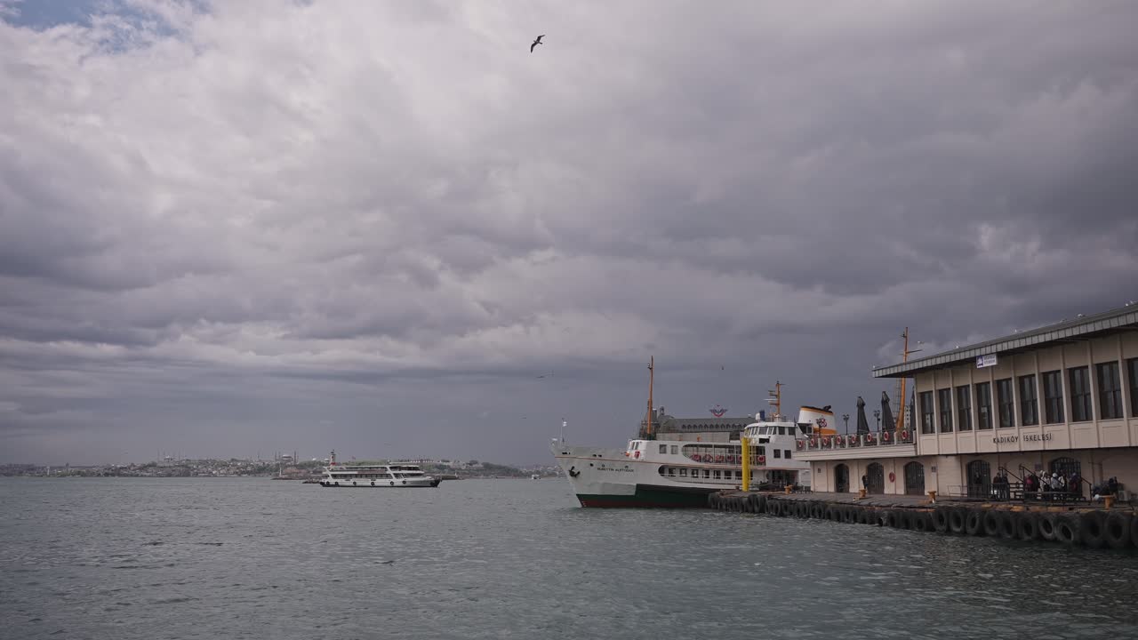 At the Kadıköy pier, in cloudy weather, ships are sailing, birds are flying, on the Bosphorus