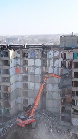 dismantling of a house. destroying old house with bulldozer mechanical arm