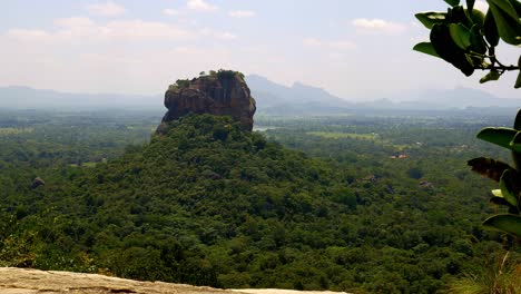 view on ancient pinnawala mountain from far away, surrounded by rainforest