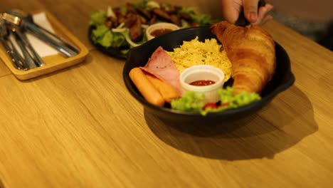 delicious breakfast plate with croissant and salad