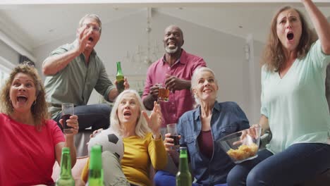Animation-of-happy-diverse-senior-friends-cheering-while-watching-american-football-match-in-tv