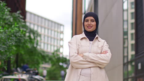 Portrait-Of-Modern-Muslim-Businesswoman-Wearing-Hijab-With-Business-Suit-Going-To-Work-Standing-Outside-Office-Building-With-Folded-Arms-4