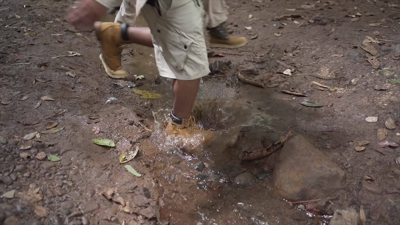 A couple running on a puddle of water or river splash
