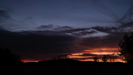 timelapse of fast moving dark clouds and warm lightrays breaking through