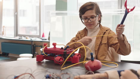 caucasian schoolboy having science lesson with classmates