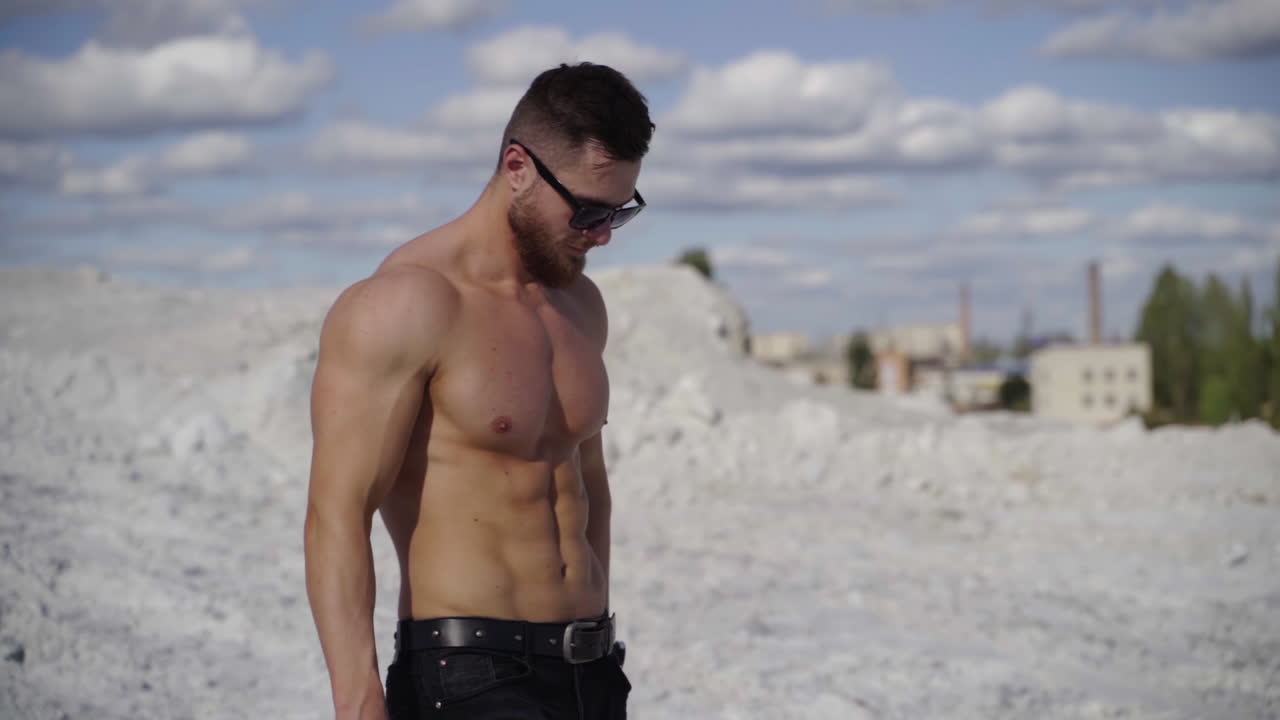 Handsome Muscular Shirtless Man. Handsome young model standing strong outdoors