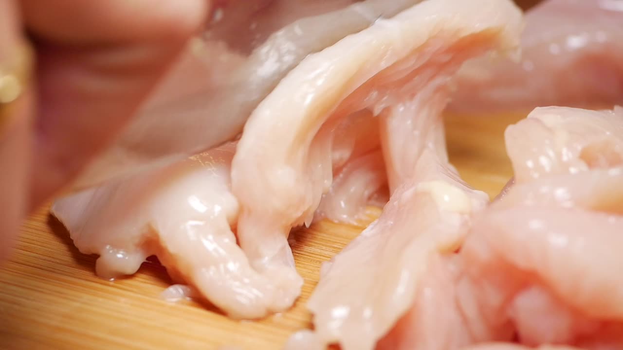Cutting Raw Chicken Breast