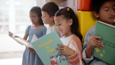 children reading books in a classroom